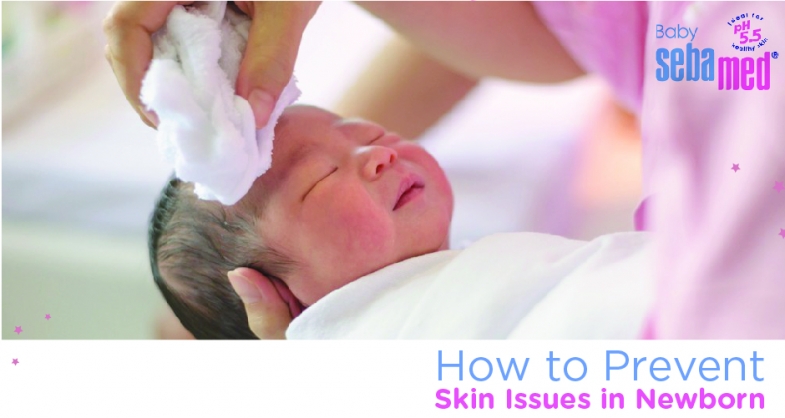 A mother cleaning baby’s face